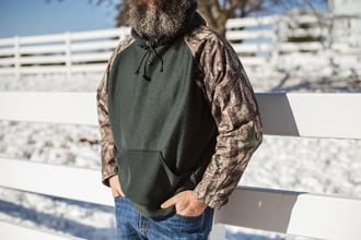 Green briar proof hoodie in green with camo sleeves.