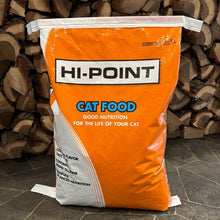 Bag of Hi-Point cat food with stacked firewood in the background