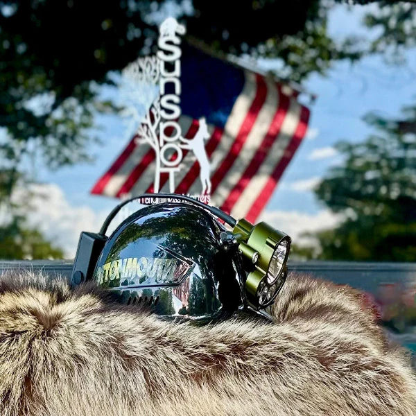 Sunspot - Helmet with a light attached, American flag in the background