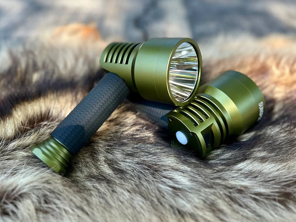 Two green flashlights on a fur surface